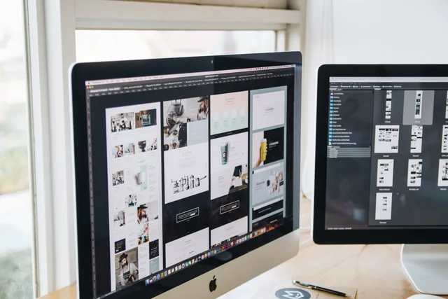 Modern office desk setup with dual monitors displaying design software, ideal for tech and business themes. Plan a prospecting software implementation for UK sales
